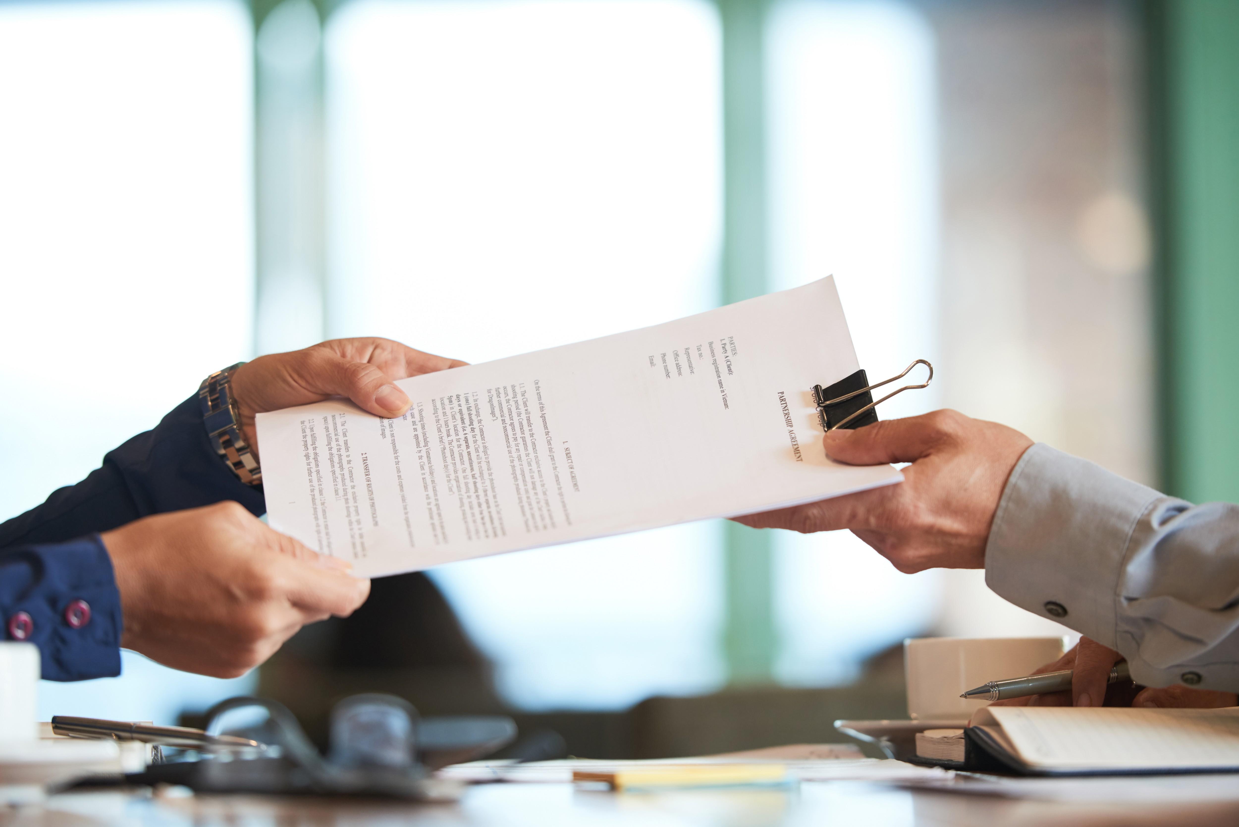 closeup-hands-passing-contract-unrecognizable-businessman (1).jpg