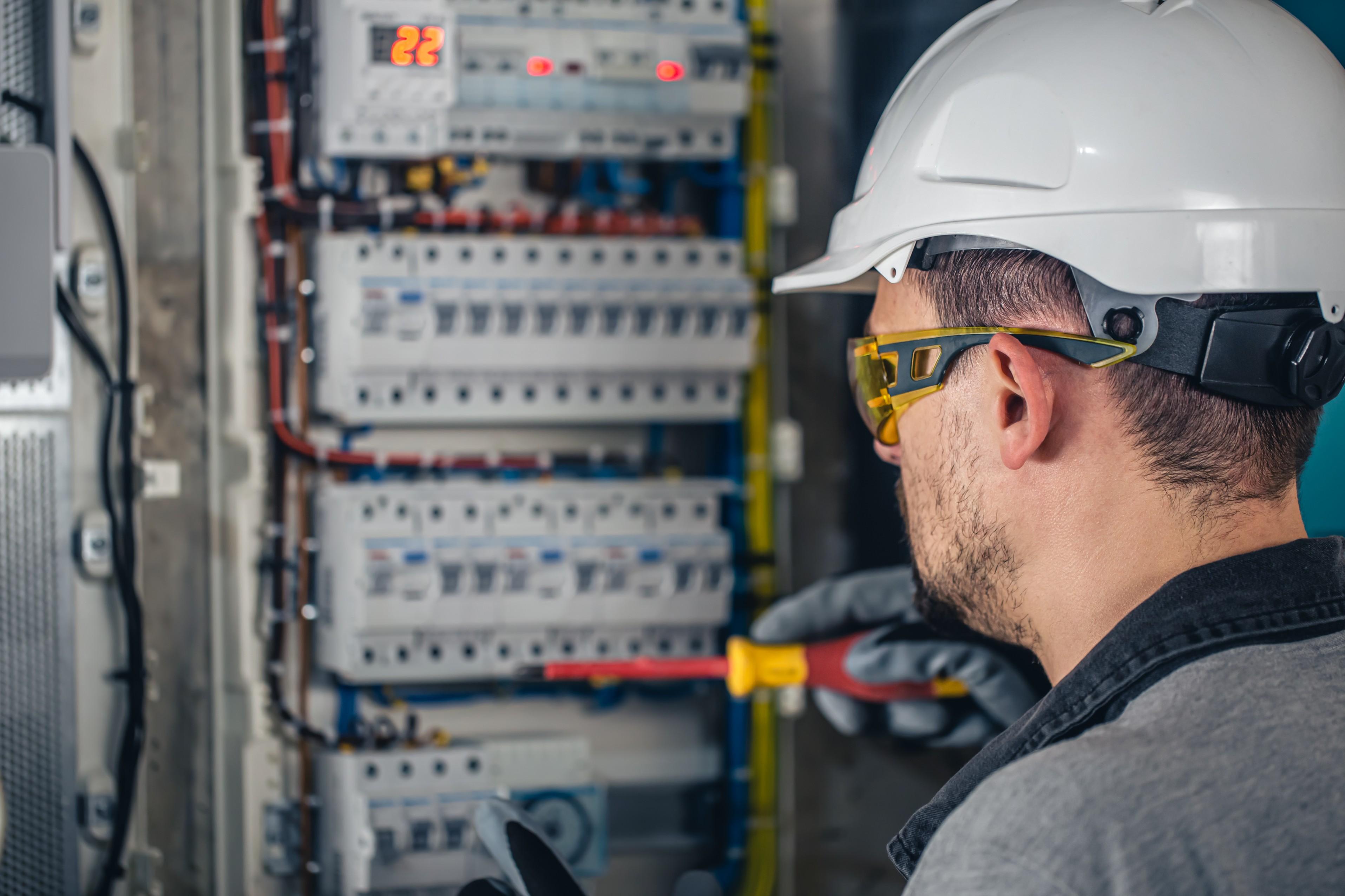 man-electrical-technician-working-switchboard-with-fuses (1).jpg