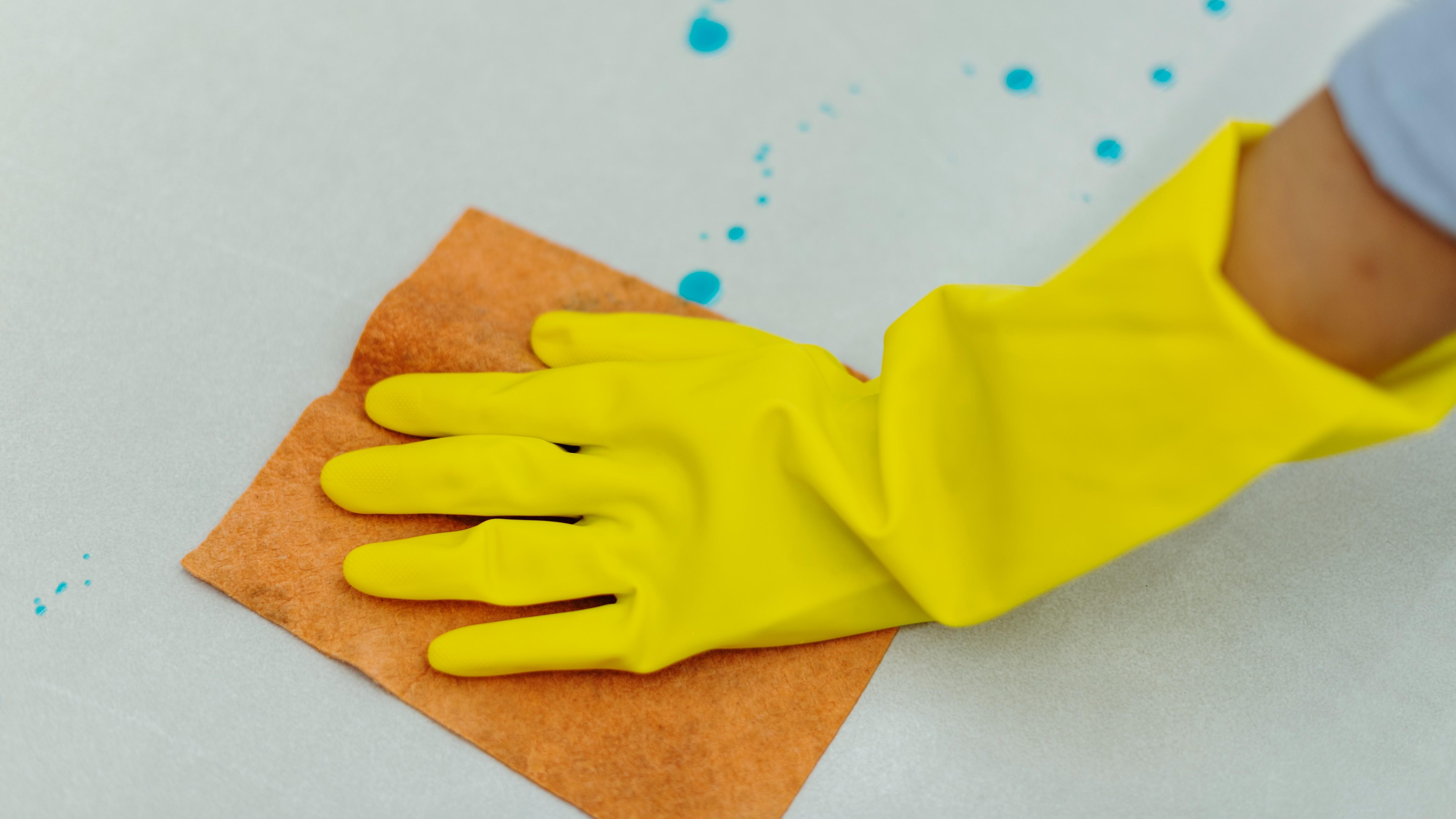 woman-wearing-yellow-rubber-gloves-cleaning-surface (1).jpg